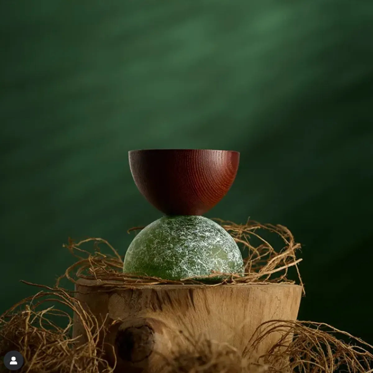 Wooden bowl on a textured surface with a green background