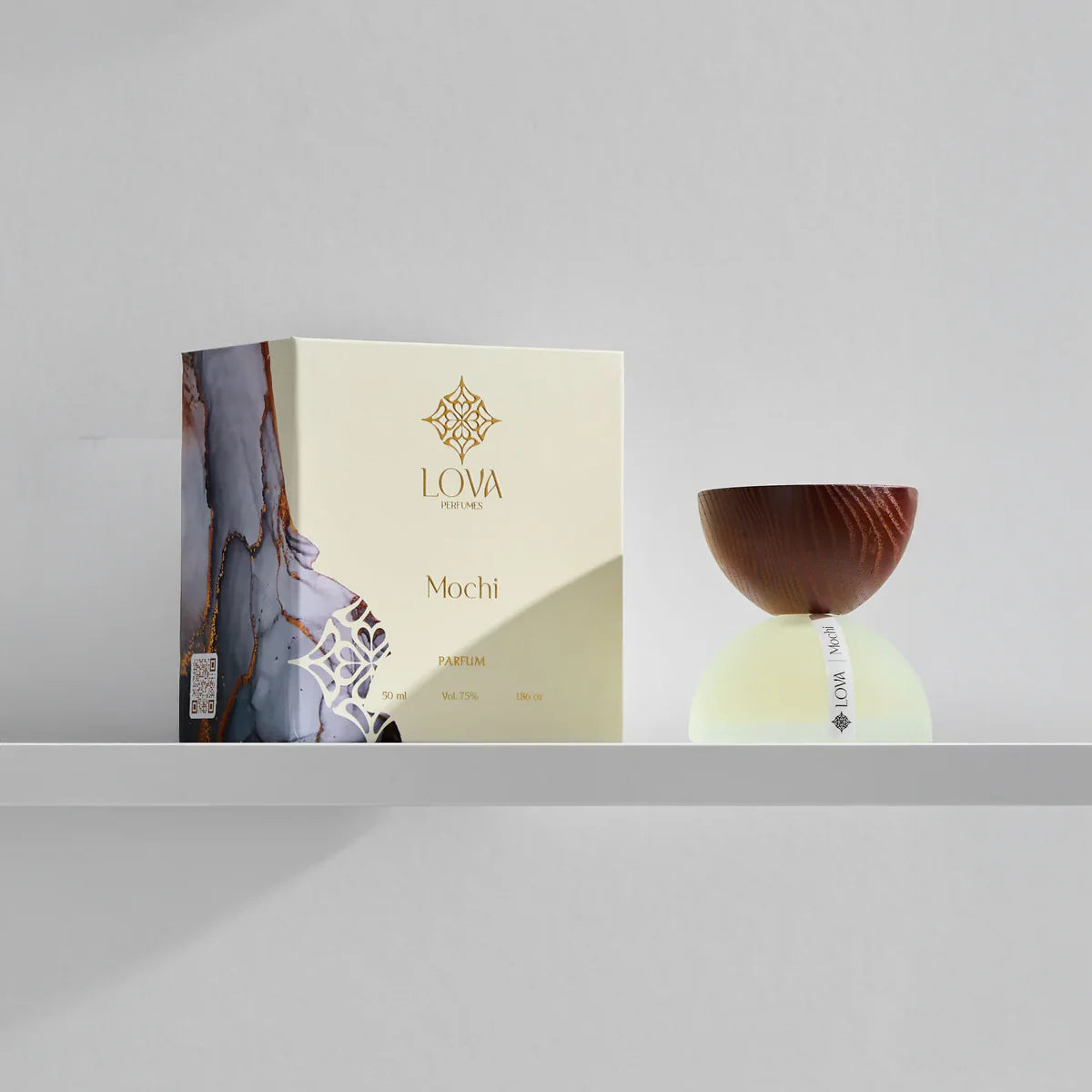 Mochi by LOVA perfume bottle with elegant packaging box on neutral grey background
