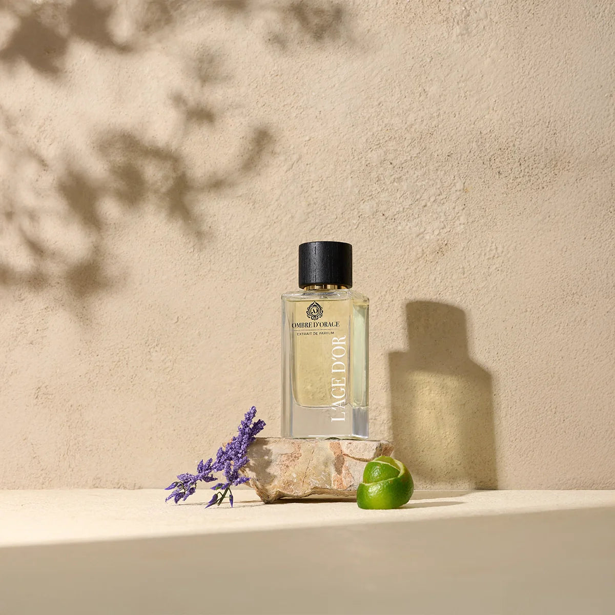 Ombre d’Orage by L’Âge d’Or luxury perfume bottle styled with lavender, lime and stone on natural beige background