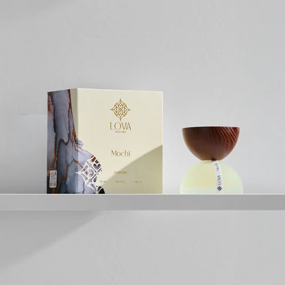 Mochi by LOVA perfume bottle with elegant packaging box on neutral grey background
