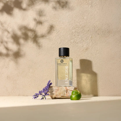 Ombre d’Orage by L’Âge d’Or luxury perfume bottle styled with lavender, lime and stone on natural beige background
