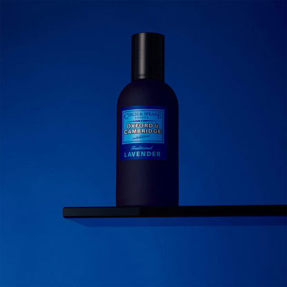 Blue bottle of C忒ch & Speake on a black shelf against a blue background