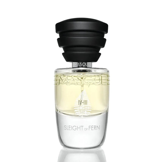 Perfume bottle labeled 'Sleight of Fern' with a black cap on a white background by Masque Milano